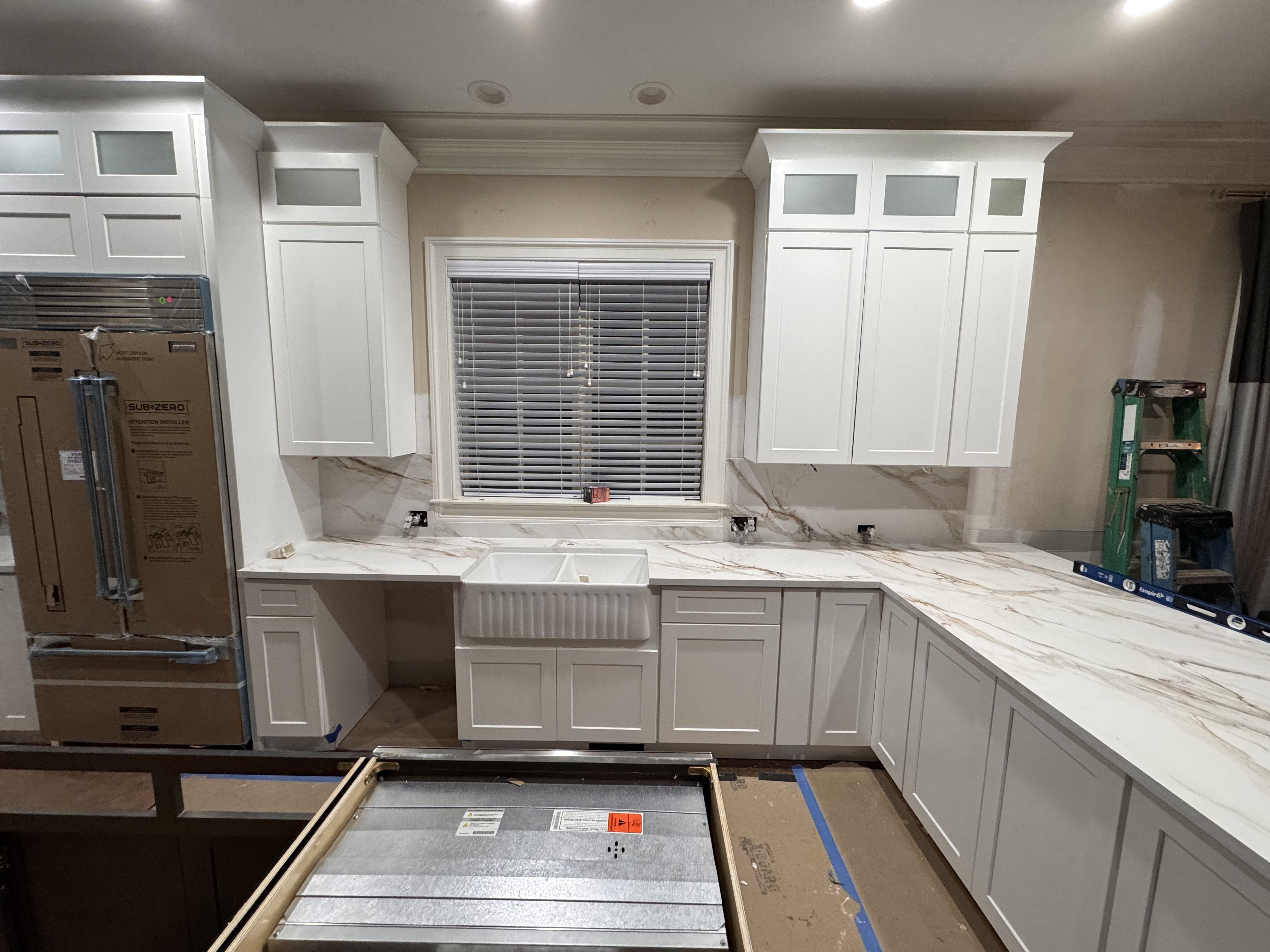 White quartz with gold veining and farmhouse sink