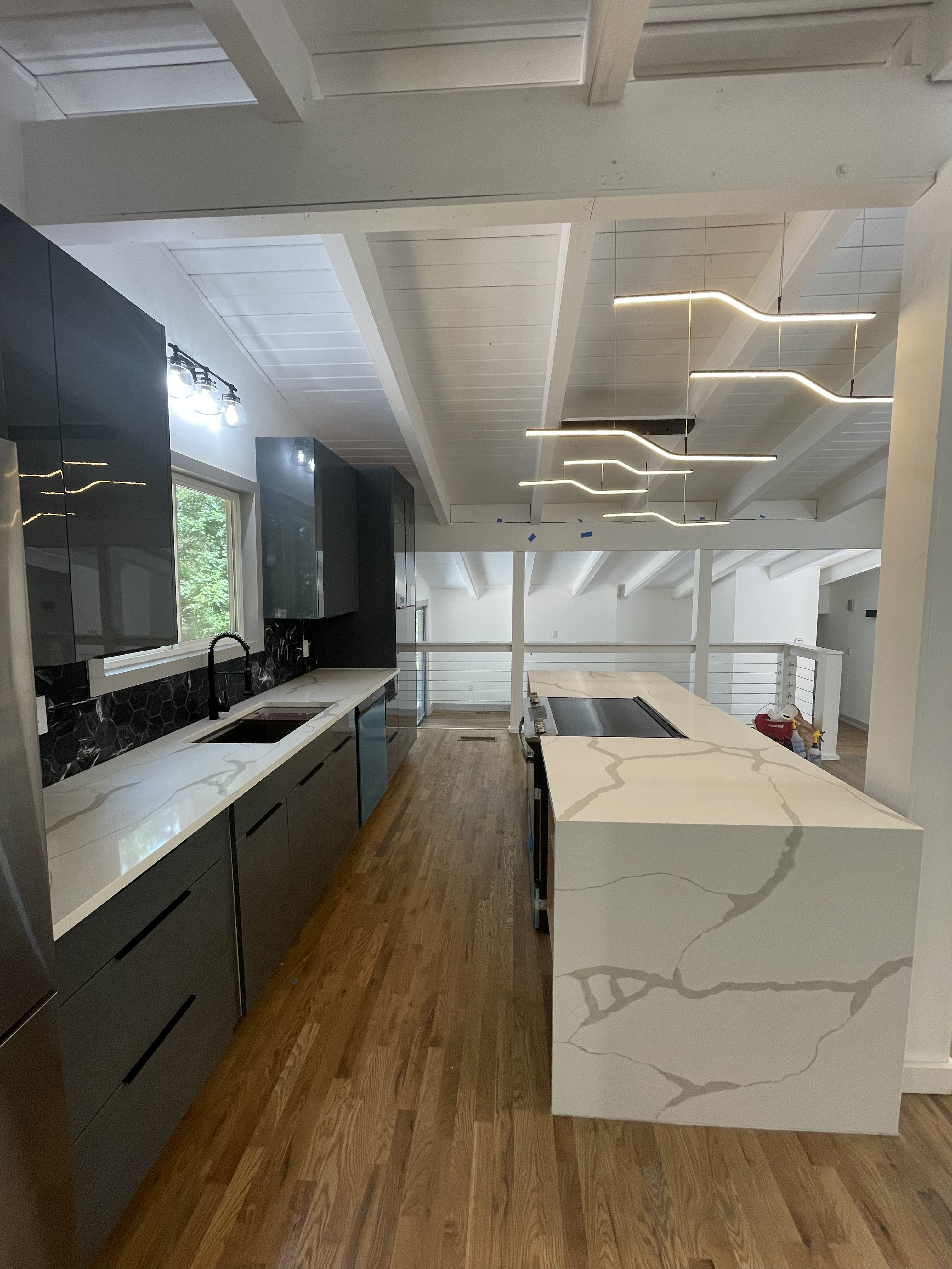 Modern kitchen with quartz waterfall island