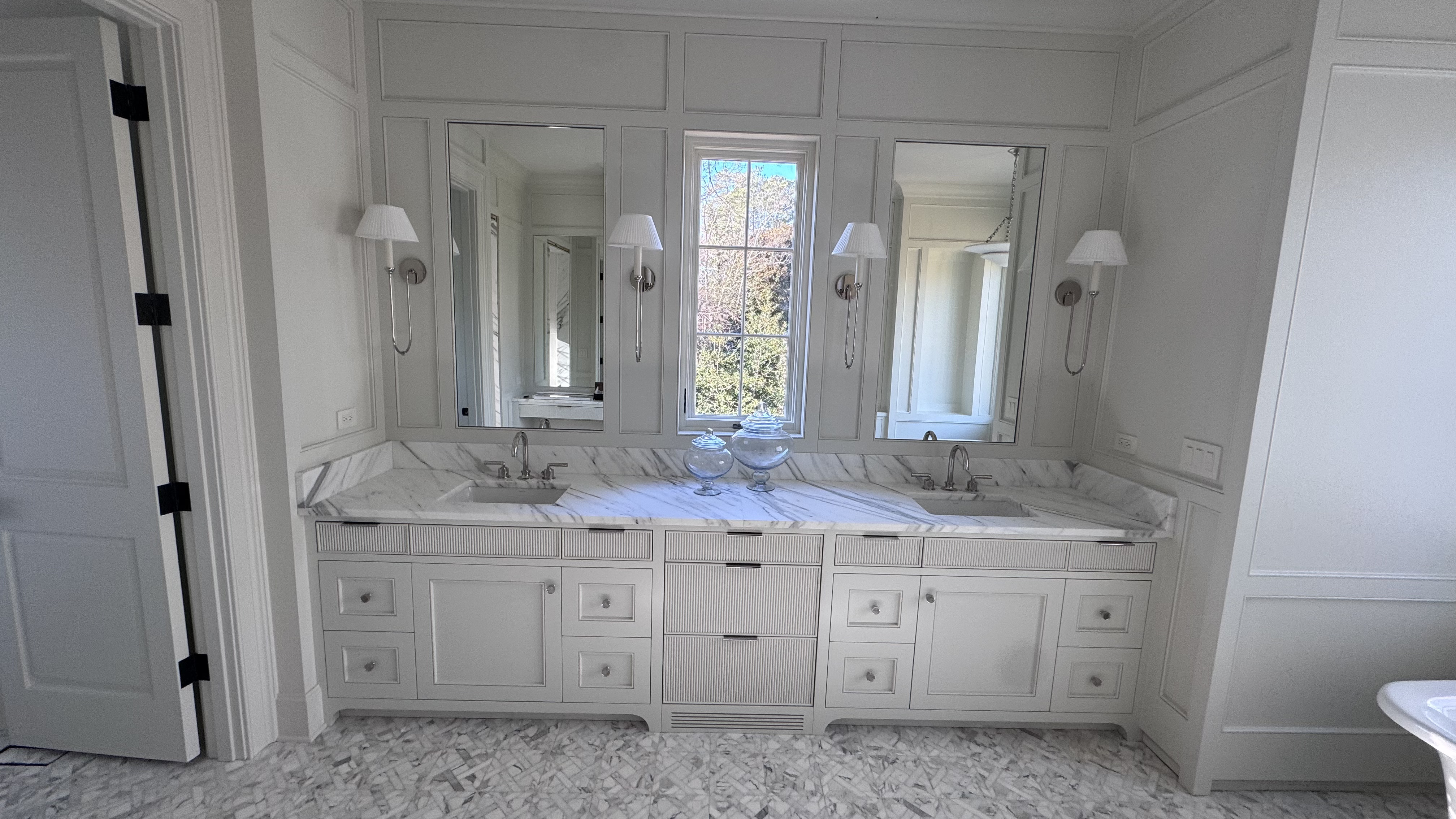 Double vanity with marble countertop and chrome fixtures